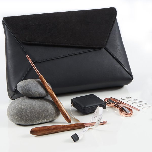 black case with copper and walnut handles crochet hook set