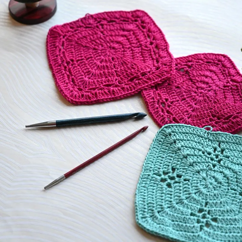 pieces of crochet work with several afghan tunisian crochet hooks